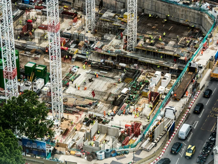 Aerial view of a large construction site with several cranes